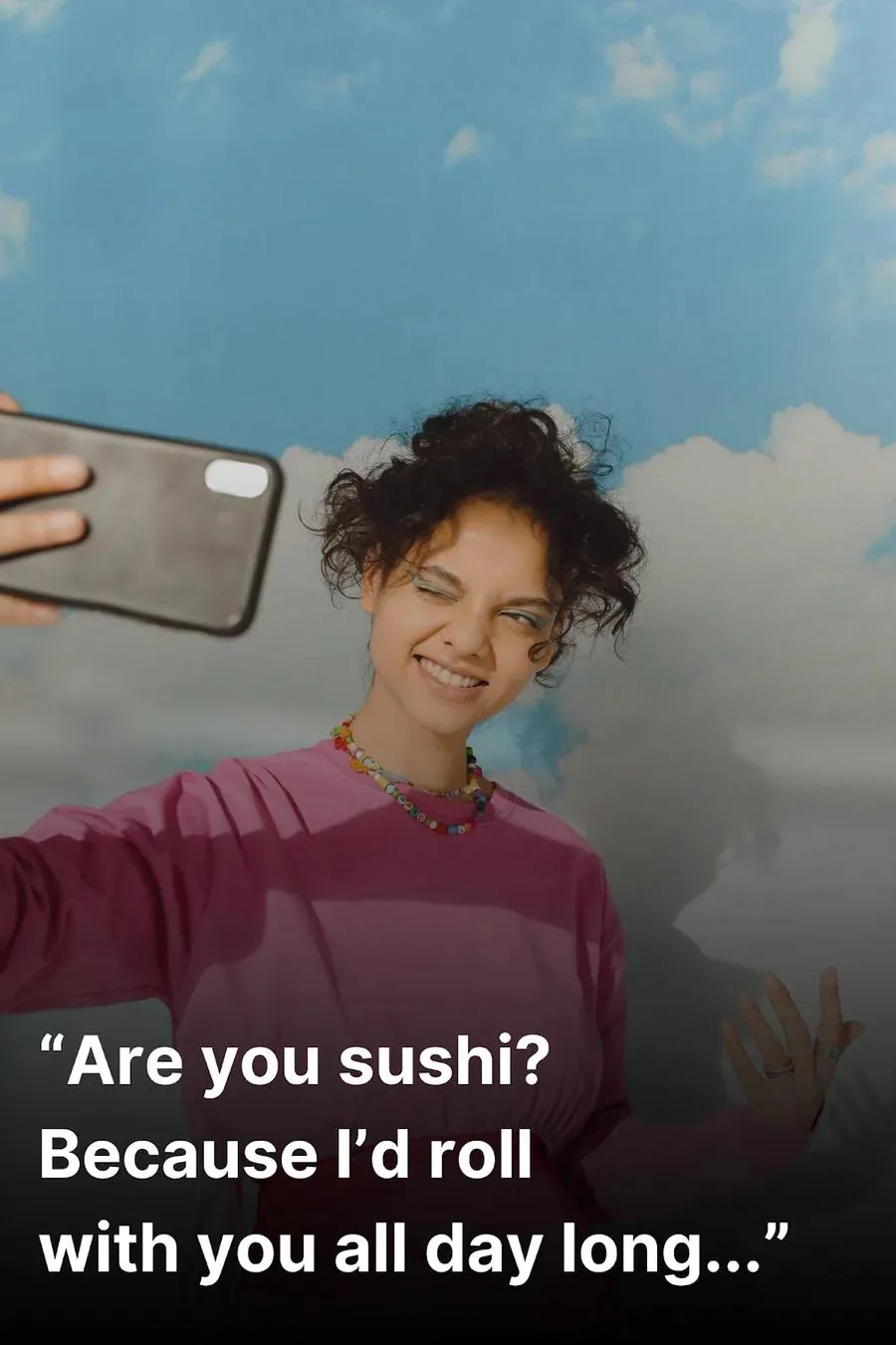 Young woman taking a selfie after hearing a clever Tinder pick up line.