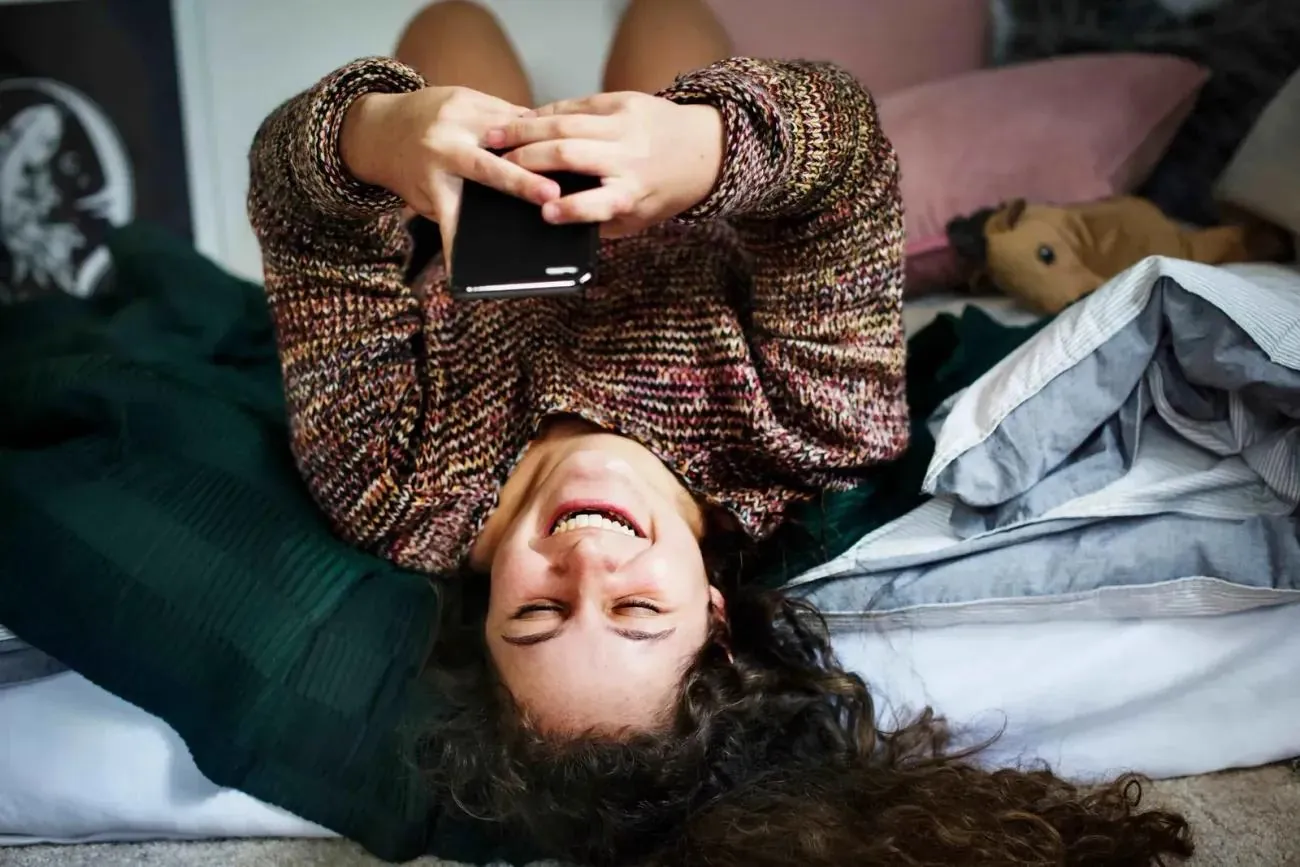 Girl on bed texting on phone. Source: © <a href='https://www.123rf.com/profile_rawpixel'>rawpixel</a>, <a href='https://www.123rf.com/free-images/'>123RF Free Images</a>