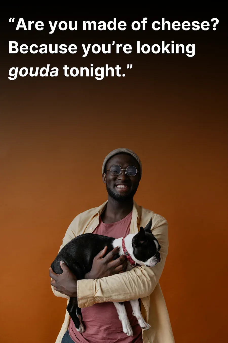 Young man with a dog on his lap laughing after hearing a funny pick up line