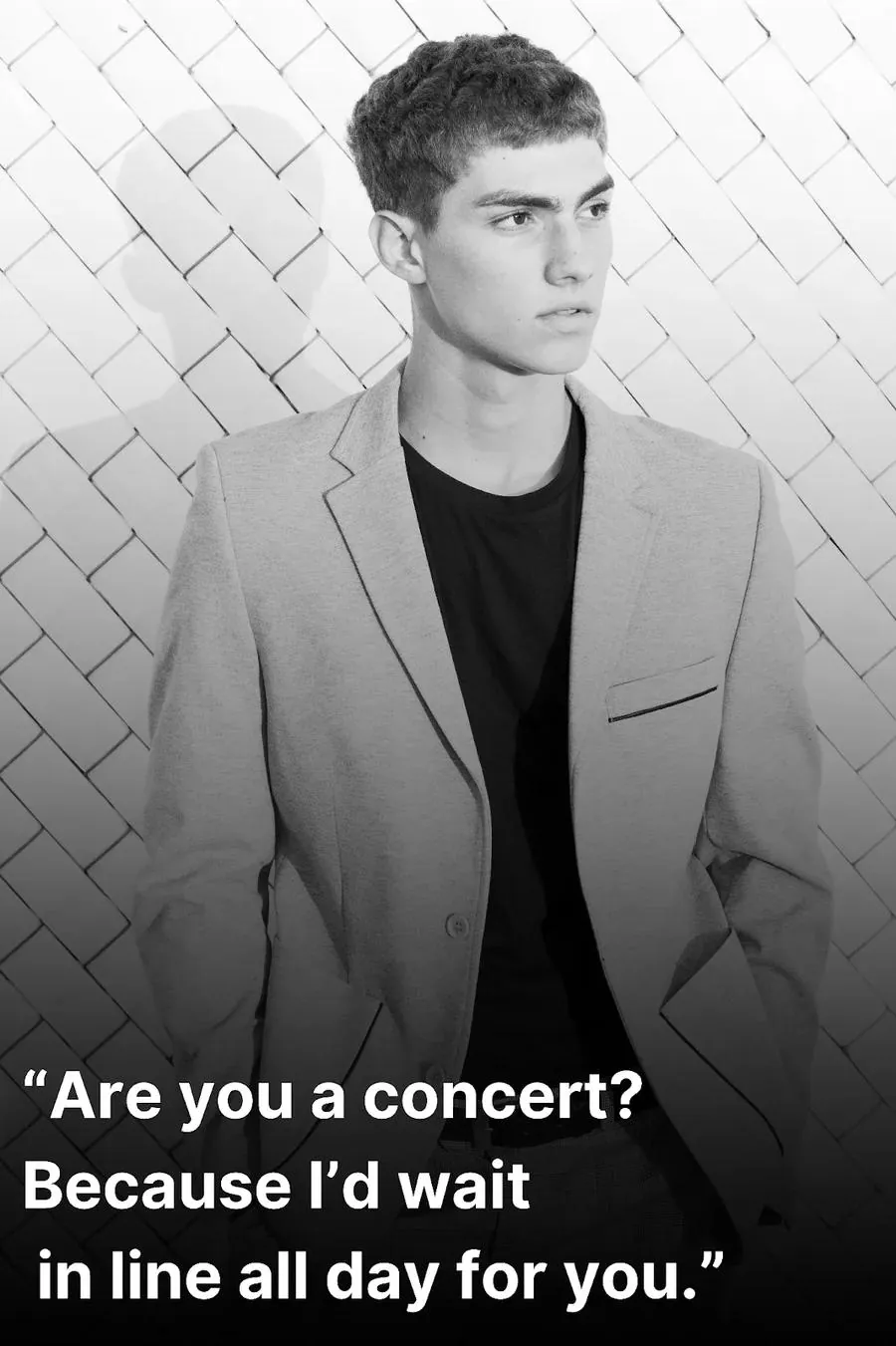 Attractive young man in a suit waiting to hear a cheesy pick up line (black and white image)